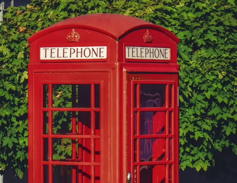 Cabina telefónica típica pintada de rojo, con inscripción en inglés de la palabra teléfono