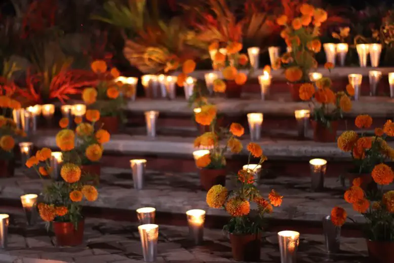 el altar de los muertos con velas y flores